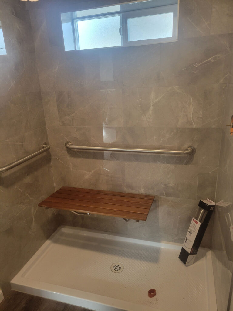 Douglas Biltzen's DB Builders modern walk-in shower with grab bar and fold-down bench in Humboldt County, CA
