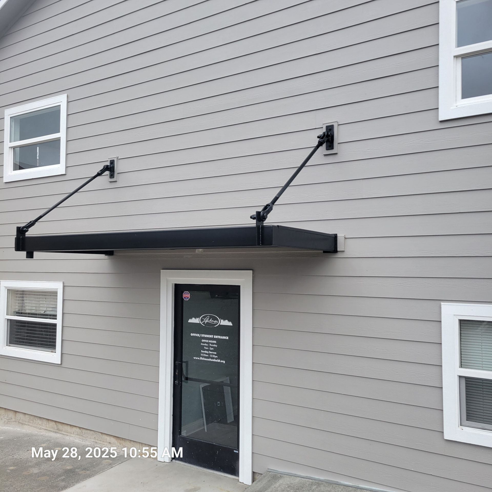 Douglas Biltzen's DB Builders installing new grey siding, windows, and modern door awning in Humboldt County, CA