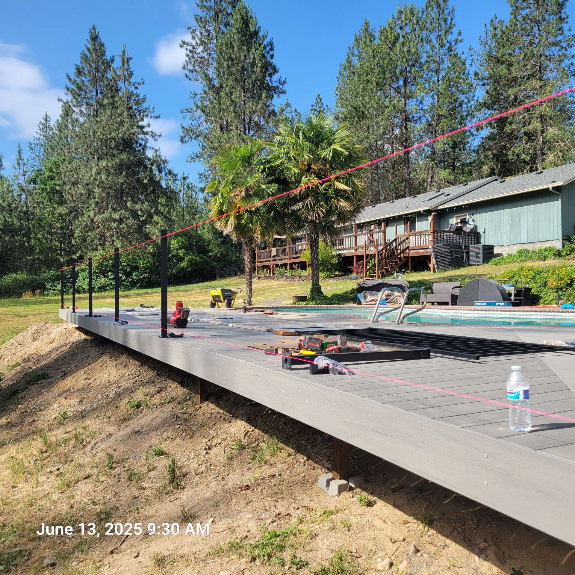 Douglas Biltzen's DB Builders installing elevated composite deck and metal railings near pool in Humboldt County, CA
